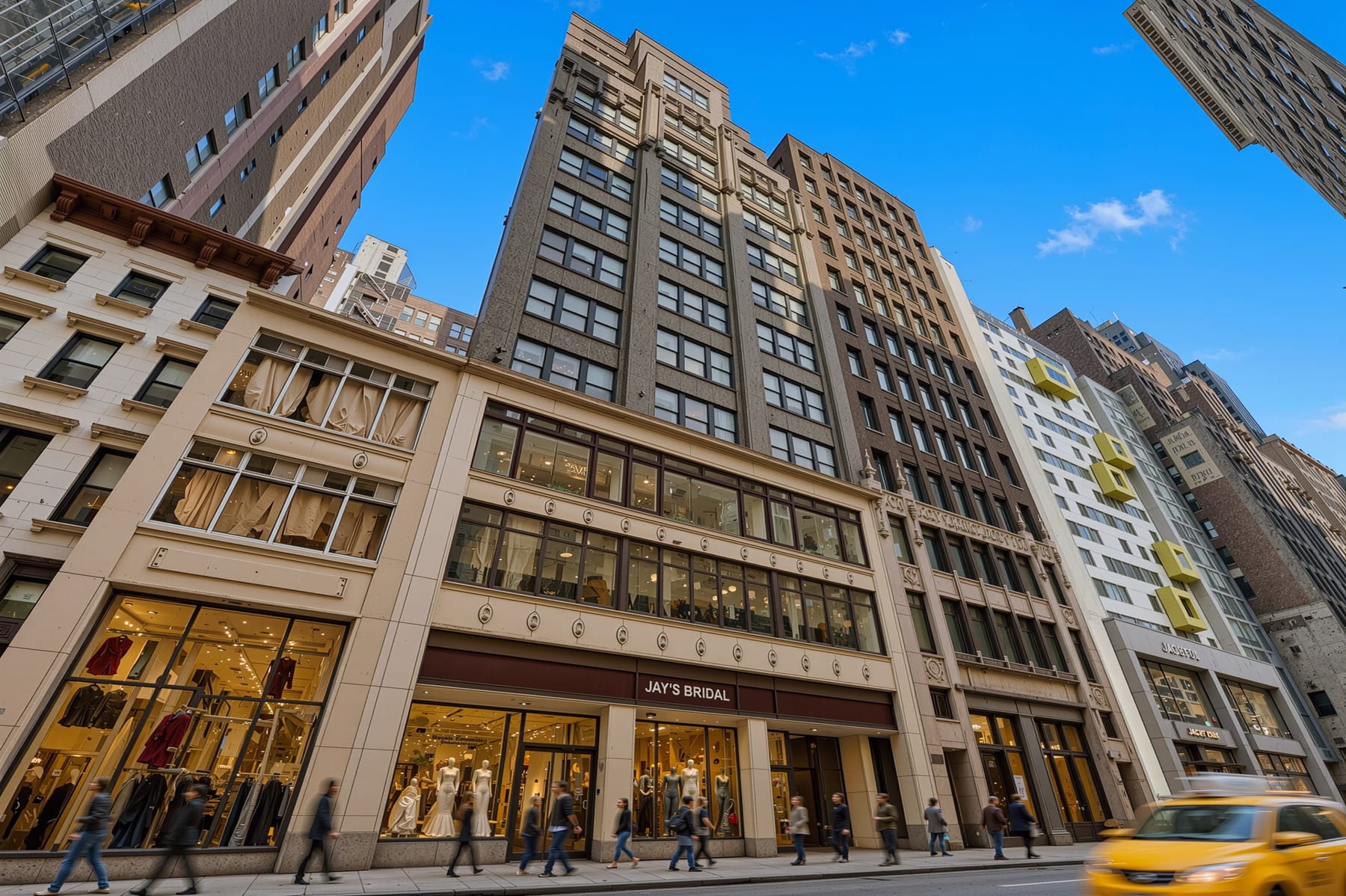 The facade from across 37th Street, full-building view with block context